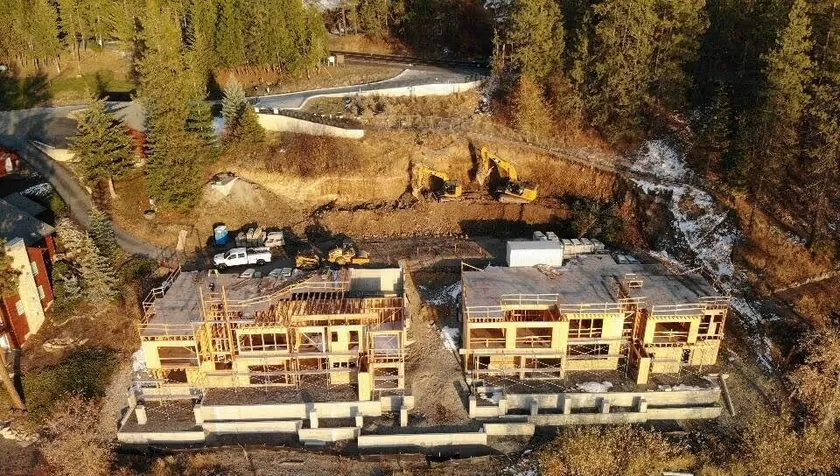 Two estate homes being built on the hillside of Hayden Lake. The foundation is laid out and the framing of both houses is going up.